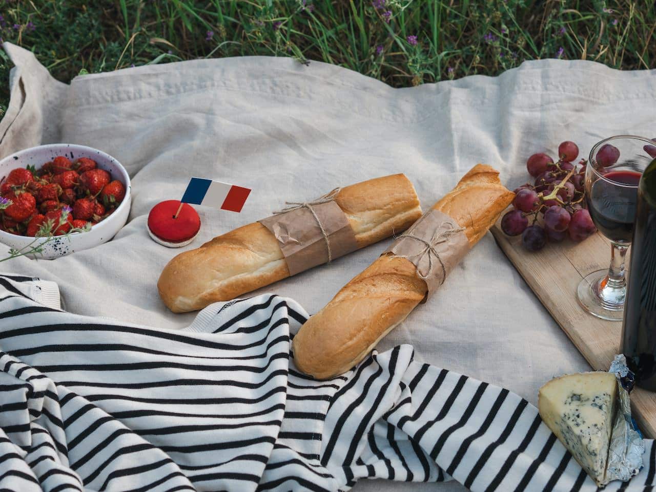 french picnic with baguette, wine and fruits