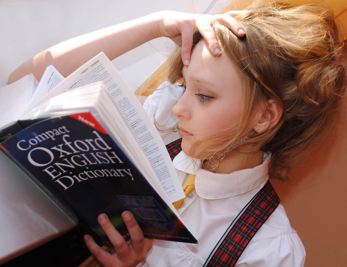 A girl reading Oxford English Dictionary. is English the easiest language to learn?